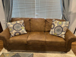 Matching taupe/light brown faux leather nailhead sofa and rocking recl