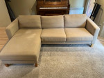 Beige L-shaped sofa with chaise and custom arm tables