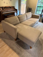 Beige L-shaped sofa with chaise and custom arm tables
