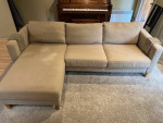 Beige L-shaped sofa with chaise and custom arm tables