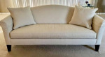 Camelback beige sofa