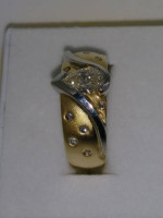 One 14 karat yellow gold ring with flush setting pear shaped diamond