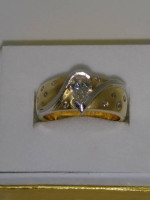 One 14 karat yellow gold ring with flush setting pear shaped diamond