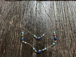 Women's longer decorative chain necklace with two shades of blue beads