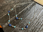Women's longer decorative chain necklace with two shades of blue beads