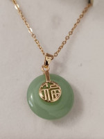 LADY'S FAUX CIRCULAR JADE PENDANT W/GOLD PLATED ORIENTAL SYMBOL