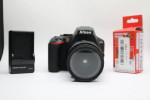Nikon D3500 Digital Camera With a Lens and lens filter.