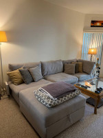 Gray Crate & Barrel sectional sofa with storage ottoman