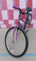 Small, purple, step-thru single-speed cruiser