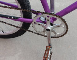 Small, purple, step-thru single-speed cruiser