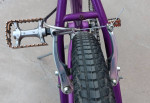Small, purple, step-thru single-speed cruiser