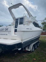 1997 Bayliner Ciera 2858 Flybridge with a triple axle aluminum trailer