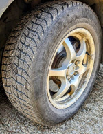 Four 255/60/R16 studded snow tires on universal alloy rims