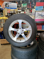 Four 17 inch Chevy rims and Firestone  tires