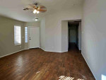 Walk into the spacious living room with natural light from multiple windows