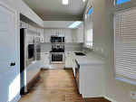 Walk into the spacious living room with natural light from multiple windows