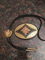 beautiful gold western buckle and bolo