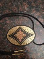 beautiful gold western buckle and bolo