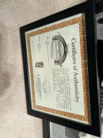 Signed anad authenticated black fender stratocaster fully encased in a hard wood