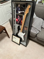 Signed anad authenticated black fender stratocaster fully encased in a hard wood