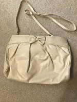 Cream colored purse with shoulder strap