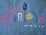 Unisex, NEW, Denim Jacket says “Serious Music” embroidered on back,Med