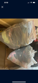Two large bags of kids’ clothes and shoes