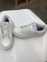 Men’s  Reebok white tie tennis shoes.