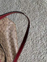 Coach satchel in signature canvas bag with red accents
