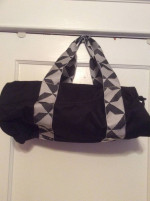 Twelve NYC smaller black Duffel bag. Adjustable shoulder strap.