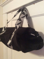 Twelve NYC smaller black Duffel bag. Adjustable shoulder strap.