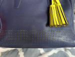 Coach Navy zipper bag with yellow tassel
